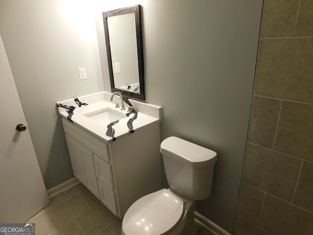bathroom with tile patterned floors, toilet, and vanity
