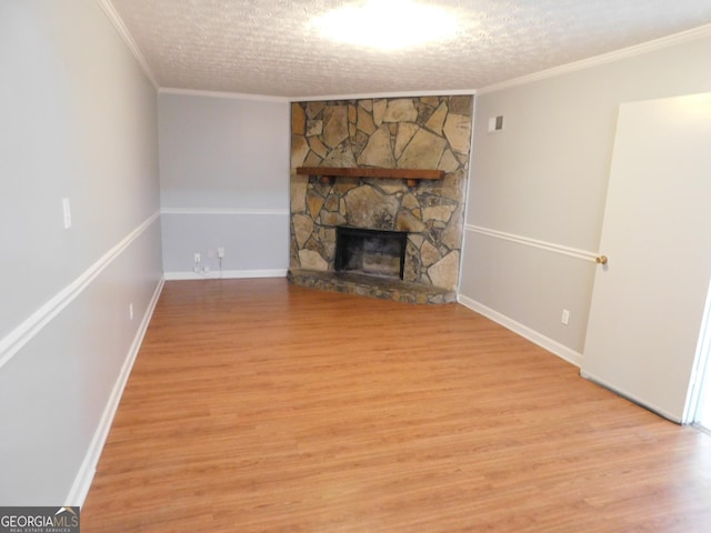 unfurnished living room featuring baseboards, ornamental molding, light wood finished floors, and a fireplace