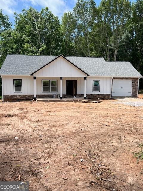 92 Old Bowdon Rd, Carrollton, GA 30117 - modern farmhouse featuring a garage, a shingled roof, and stone siding
