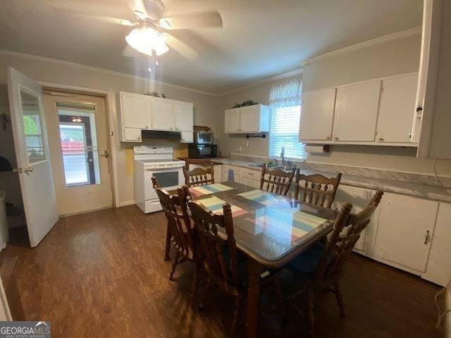 dining space featuring crown molding, dark wood-type flooring, and ceiling fan