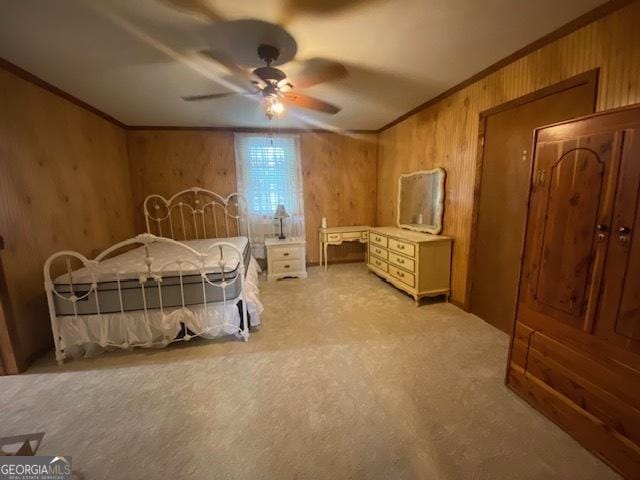 bedroom with crown molding, wood walls, ceiling fan, and light carpet