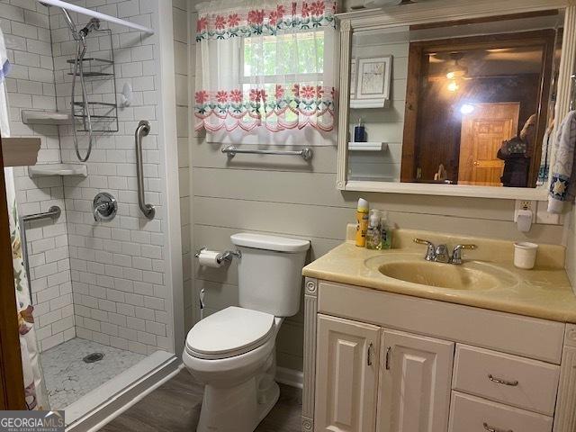 bathroom featuring a stall shower, vanity, and toilet