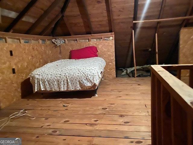 bedroom featuring vaulted ceiling, wooden ceiling, and hardwood / wood-style flooring