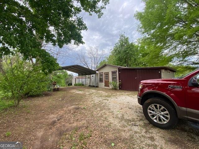view of home's exterior featuring driveway and a carport