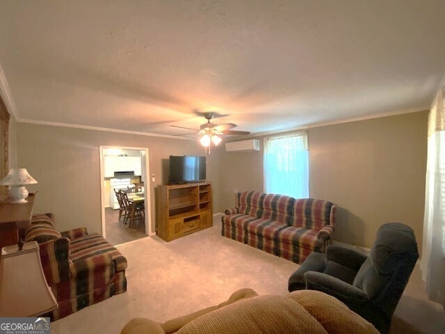 living area featuring ornamental molding, a wall mounted air conditioner, carpet flooring, and a ceiling fan