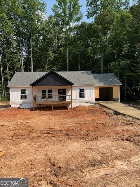 22 Summer Ct, Carrollton, GA 30116 - view of front facade with concrete driveway, view of wooded area, and roof with shingles