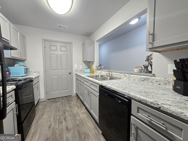 3202 Fairington Village Dr, Lithonia, GA 30038 - kitchen with light wood-style flooring, a sink, visible vents, gray cabinets, and black appliances