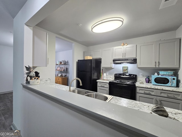 3202 Fairington Village Dr, Lithonia, GA 30038 - kitchen with under cabinet range hood, light countertops, visible vents, a sink, and black appliances