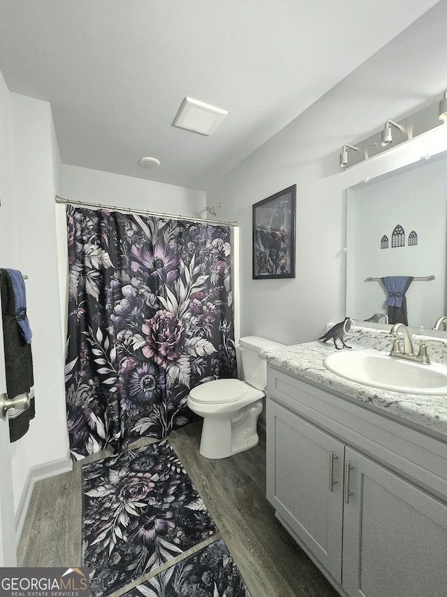 3202 Fairington Village Dr, Lithonia, GA 30038 - full bath featuring curtained shower, wood finished floors, toilet, and vanity