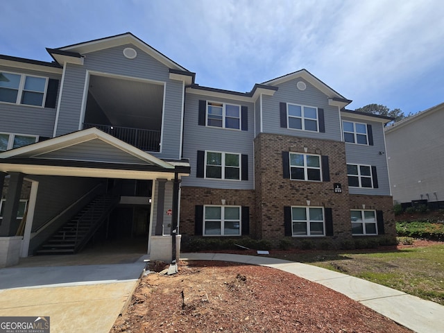 3202 Fairington Village Dr, Lithonia, GA 30038 - townhome / multi-family property featuring brick siding, driveway, and stairway