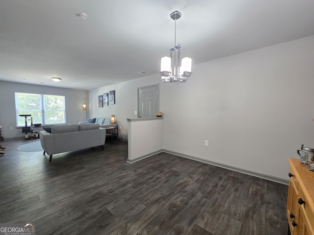 3202 Fairington Village Dr, Lithonia, GA 30038 - living area featuring baseboards, dark wood-style floors, and an inviting chandelier