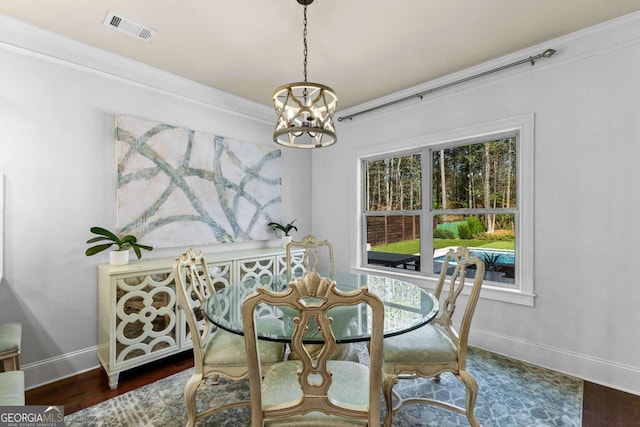 dining room featuring baseboards, a notable chandelier, visible vents, and a wealth of natural light