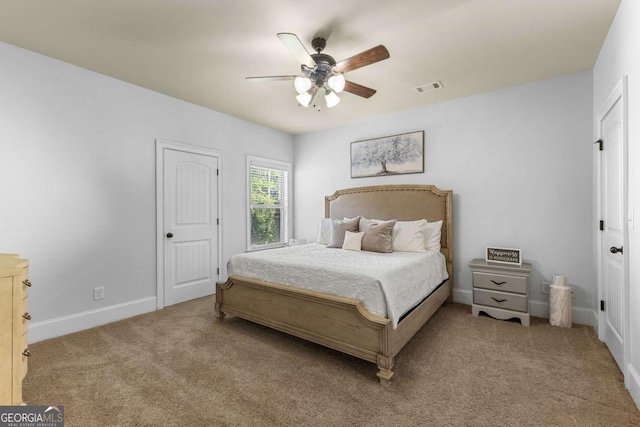 carpeted bedroom featuring ceiling fan, baseboards, and visible vents