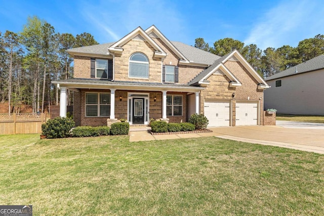 view of front facade with fence, concrete driveway, covered porch, brick siding, and a front yard