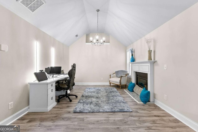 home office featuring a chandelier, lofted ceiling, visible vents, and baseboards