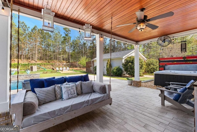 view of patio / terrace featuring a swimming pool, a hot tub, ceiling fan, and an outdoor living space