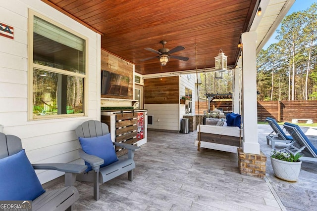 view of patio / terrace with fence and ceiling fan