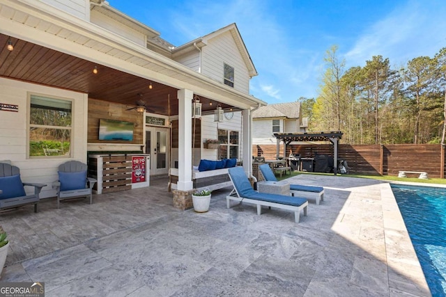 view of patio / terrace with a fenced in pool, a pergola, fence, ceiling fan, and an outdoor hangout area