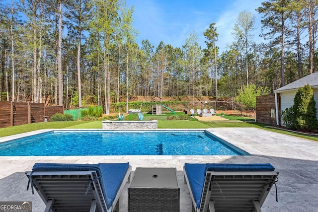 view of pool with fence, a fenced in pool, a yard, and a patio