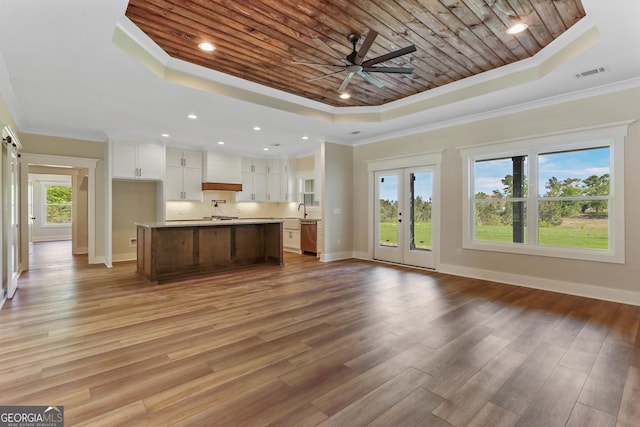 88 Northshore Ave, Jesup, GA 31545 - unfurnished living room featuring a raised ceiling, light wood-style floors, wood ceiling, and ornamental molding