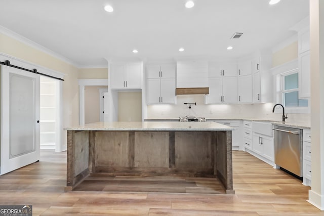88 Northshore Ave, Jesup, GA 31545 - kitchen featuring a barn door, crown molding, dishwasher, custom range hood, and visible vents