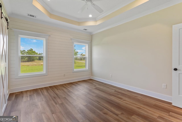 88 Northshore Ave, Jesup, GA 31545 - spare room featuring visible vents, wood finished floors, a tray ceiling, and a barn door