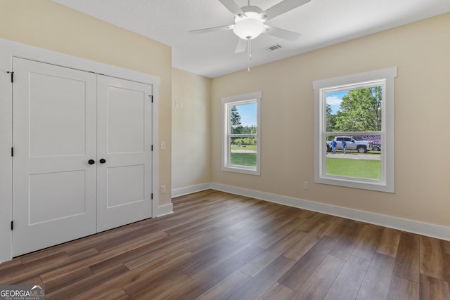 88 Northshore Ave, Jesup, GA 31545 - unfurnished bedroom featuring wood finished floors, a closet, baseboards, and ceiling fan