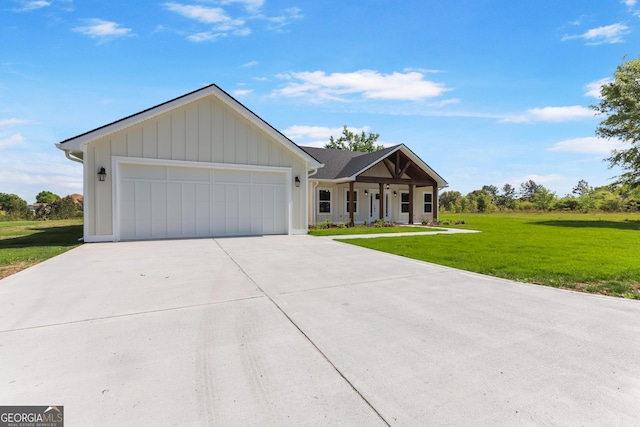 88 Northshore Ave, Jesup, GA 31545 - modern inspired farmhouse featuring a front lawn, driveway, a porch, an attached garage, and board and batten siding