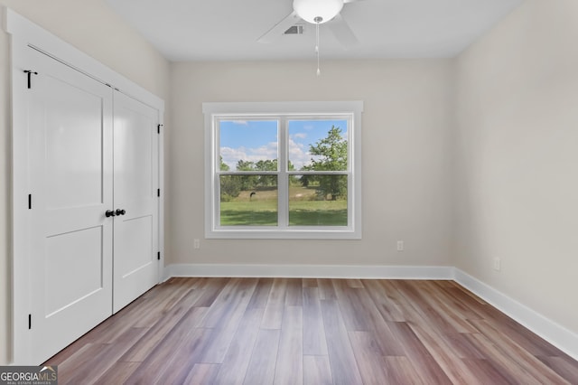88 Northshore Ave, Jesup, GA 31545 - unfurnished bedroom featuring baseboards, a ceiling fan, wood finished floors, and a closet