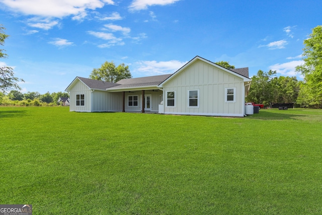 88 Northshore Ave, Jesup, GA 31545 - back of property featuring a lawn, a ceiling fan, board and batten siding, and a shingled roof