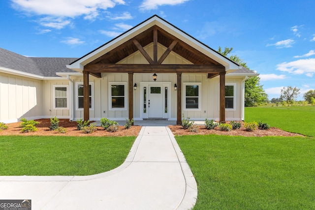 88 Northshore Ave, Jesup, GA 31545 - view of front of house featuring roof with shingles, a porch, board and batten siding, and a front yard