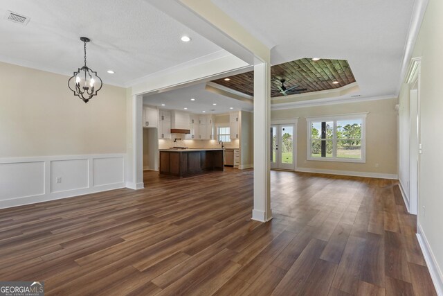 88 Northshore Ave, Jesup, GA 31545 - unfurnished living room with ornamental molding, a raised ceiling, baseboards, dark wood-style flooring, and visible vents