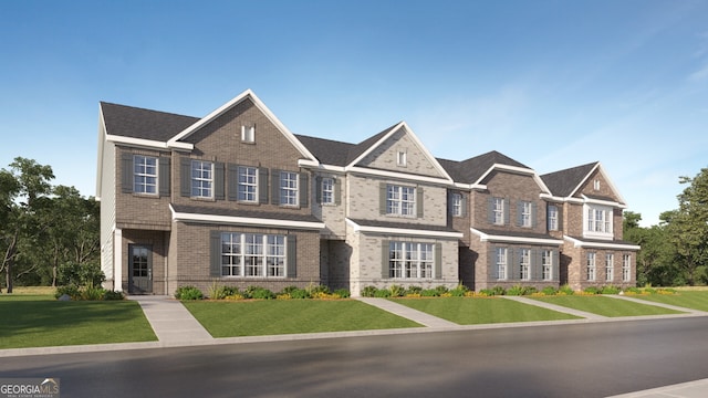 townhome / multi-family property featuring brick siding and a front lawn
