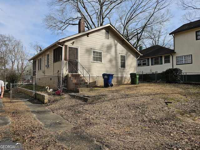 exterior space featuring crawl space, fence, a chimney, and entry steps