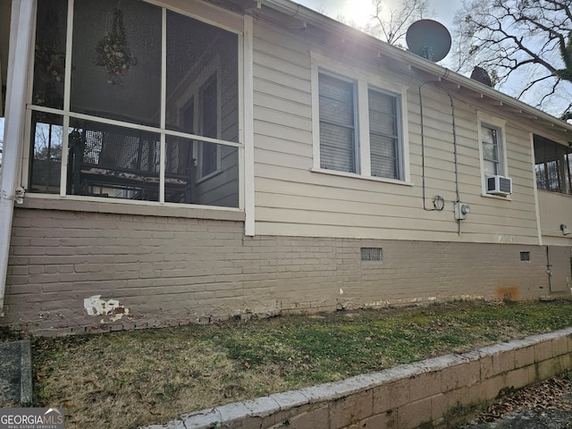 view of home's exterior with crawl space, cooling unit, and a sunroom