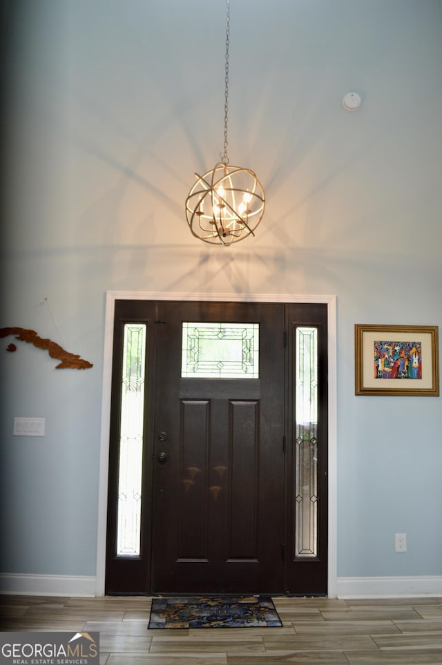 3440 Camelot Way, Loganville, GA 30052 - foyer with baseboards, a chandelier, and plenty of natural light