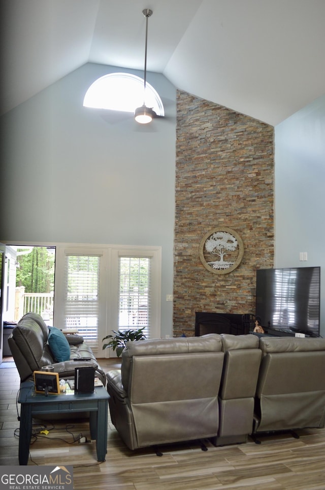 3440 Camelot Way, Loganville, GA 30052 - living room with a fireplace, high vaulted ceiling, and light wood-type flooring