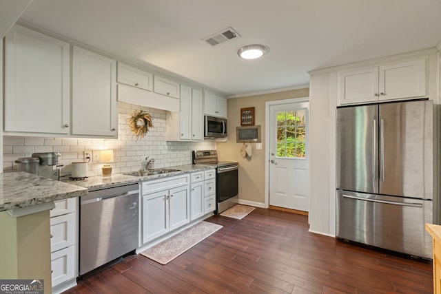 115 Maple Leaf Dr, Dahlonega, GA 30533 - kitchen featuring white cabinetry, decorative backsplash, stainless steel appliances, a sink, and baseboards