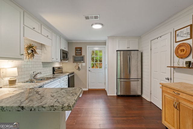 115 Maple Leaf Dr, Dahlonega, GA 30533 - kitchen with light stone counters, decorative backsplash, a sink, appliances with stainless steel finishes, and dark wood-style floors