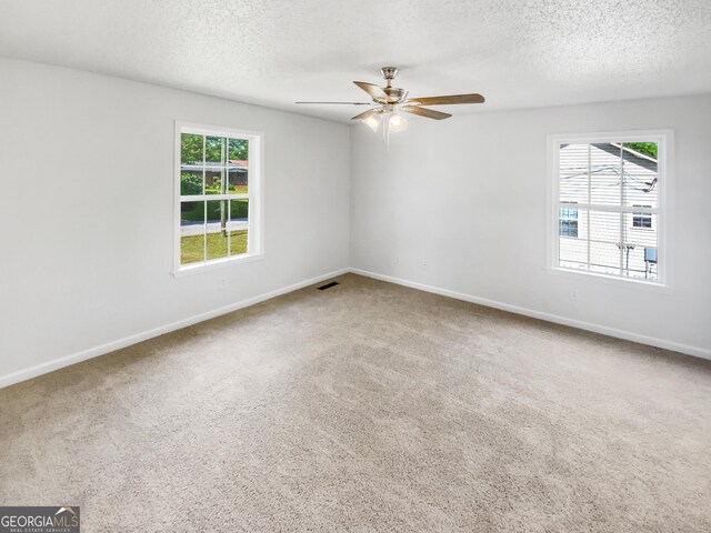 45 Carroll St, Temple, GA 30179 - carpeted empty room with a textured ceiling, visible vents, baseboards, and ceiling fan