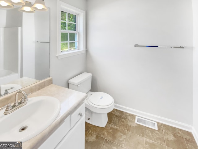 45 Carroll St, Temple, GA 30179 - full bathroom with baseboards, toilet, vanity, and visible vents