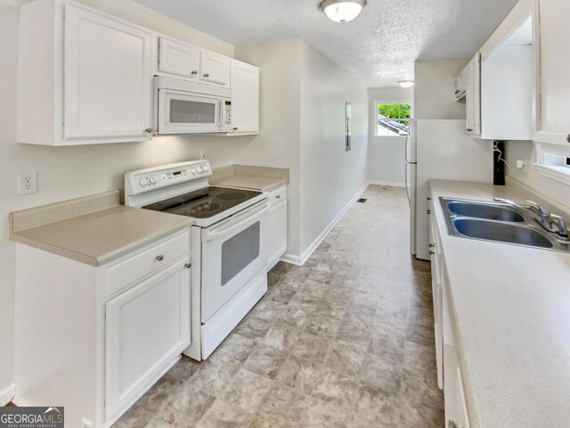45 Carroll St, Temple, GA 30179 - kitchen featuring a textured ceiling, a sink, white cabinetry, white appliances, and light countertops