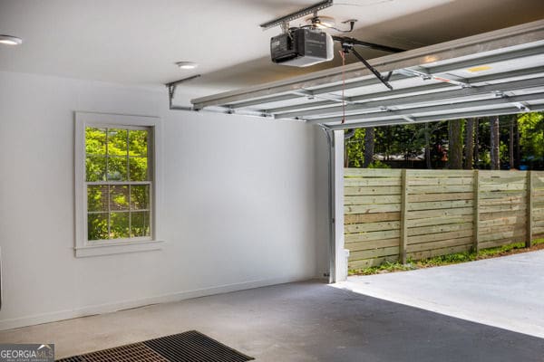 garage with a garage door opener and baseboards