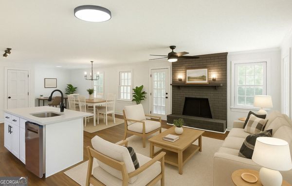 living room with ceiling fan with notable chandelier, a fireplace, and dark wood-type flooring