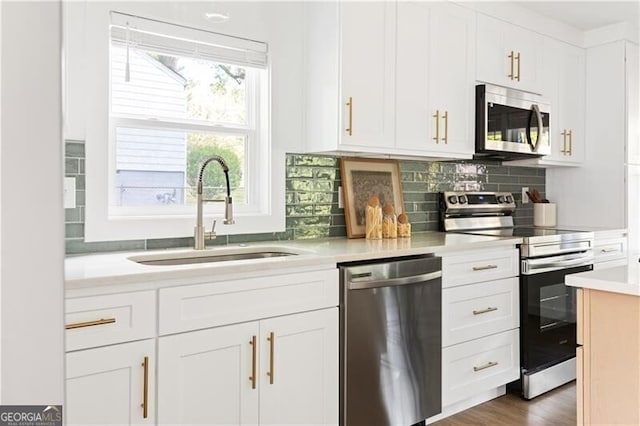 2086 Harold Ave SE, Smyrna, GA 30080 - kitchen featuring stainless steel appliances, a sink, light countertops, tasteful backsplash, and white cabinets