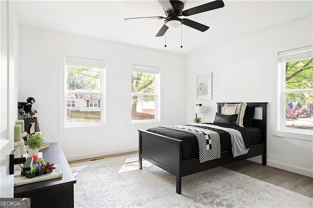 2086 Harold Ave SE, Smyrna, GA 30080 - bedroom with multiple windows, wood finished floors, baseboards, and a ceiling fan