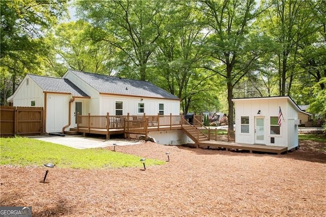 2086 Harold Ave SE, Smyrna, GA 30080 - rear view of property with a deck, board and batten siding, and view of wooded area