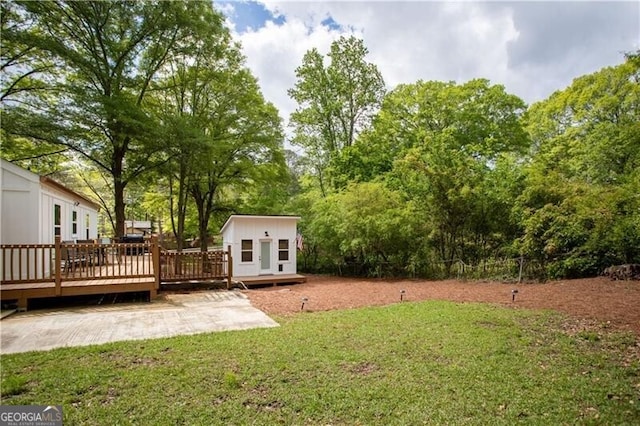 2086 Harold Ave SE, Smyrna, GA 30080 - view of green lawn featuring a wooden deck, an outdoor structure, and view of wooded area