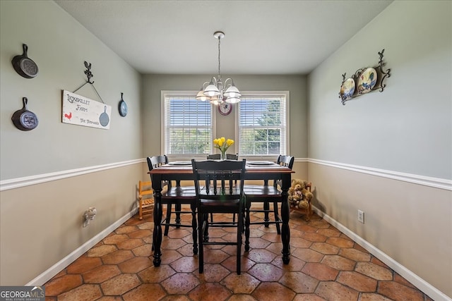 dining room featuring baseboards and a chandelier