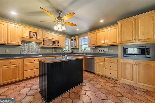 kitchen featuring dark countertops, light brown cabinetry, stainless steel appliances, and recessed lighting